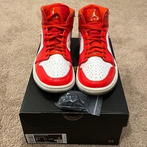 Red and white air Jordan’s, with laces, and the box and wrapping paper.